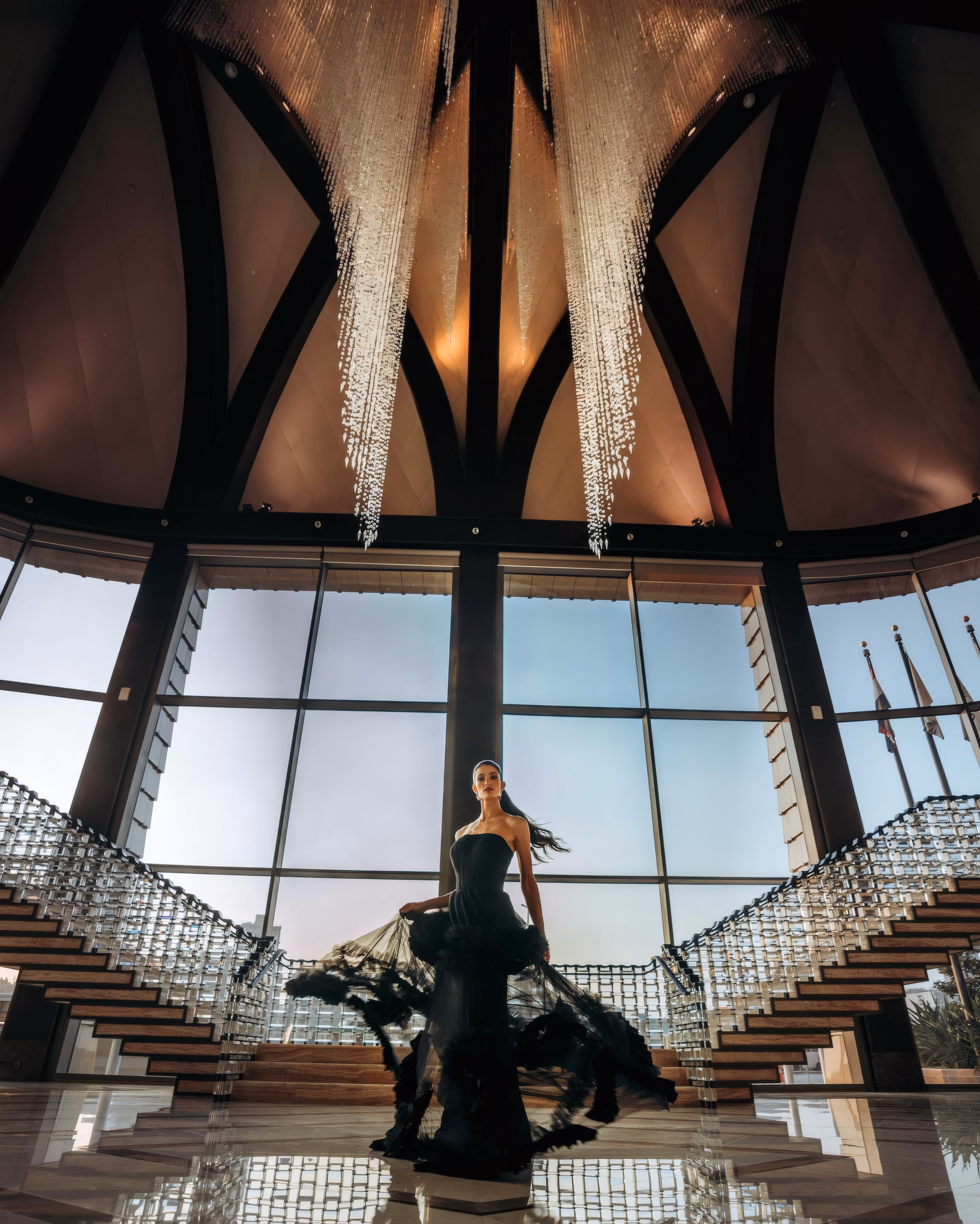 A person framed by the curves and arches of an interior.