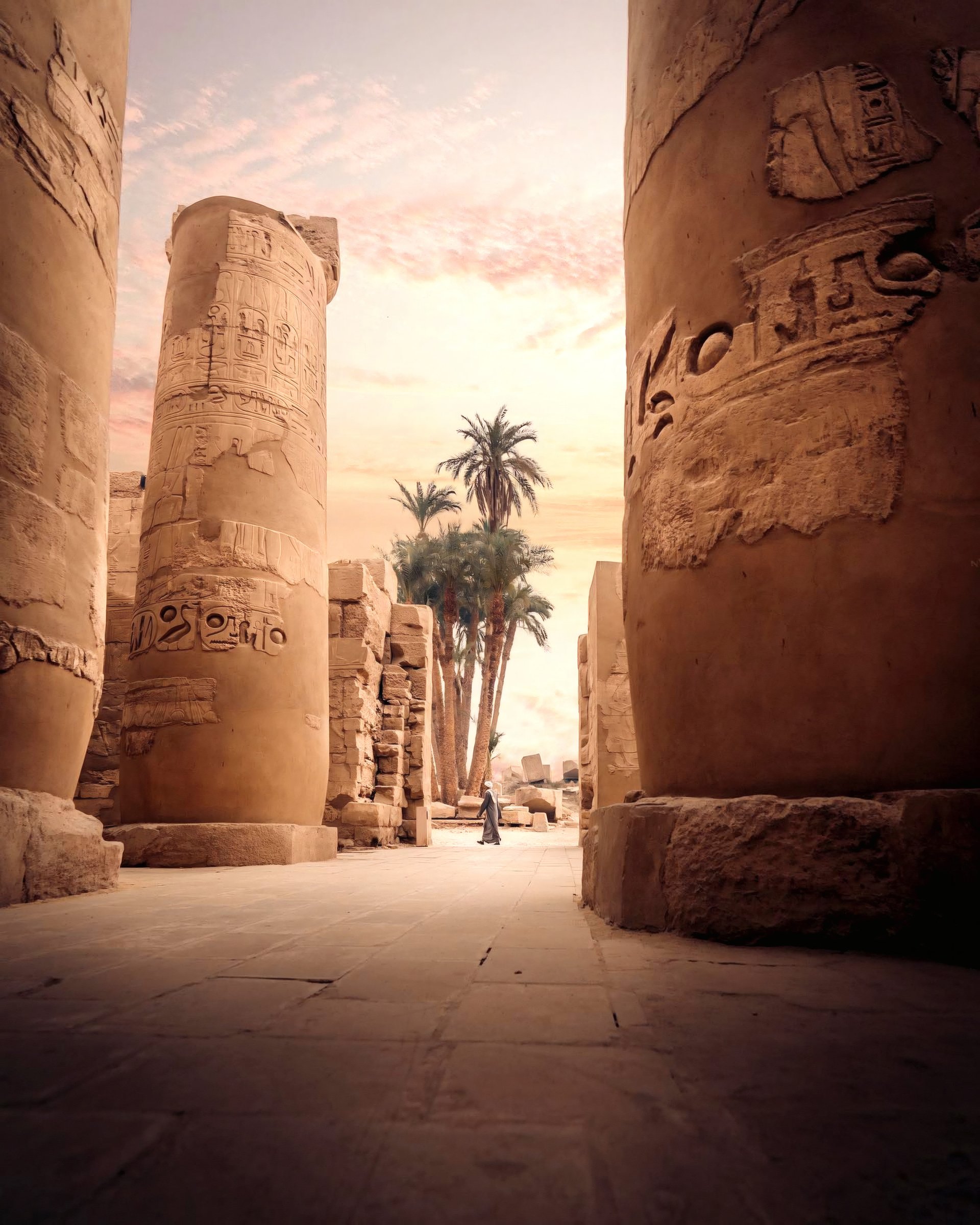 Sunlight falling between ancient decorated stone columns.
